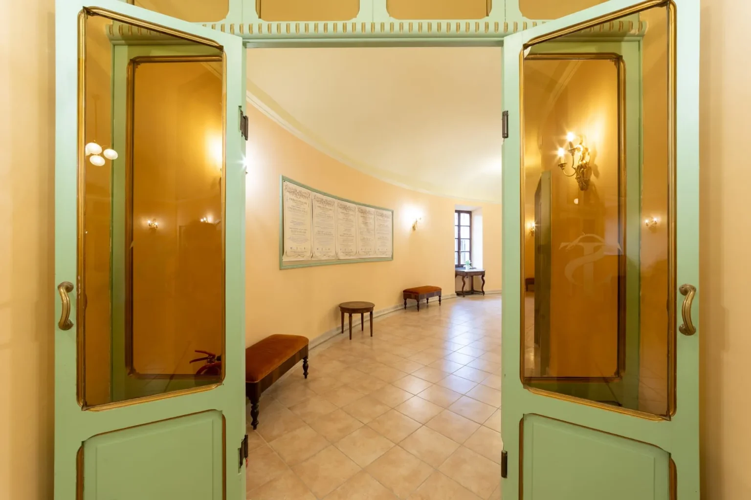 Il foyer con le porte verdi decorate in oro